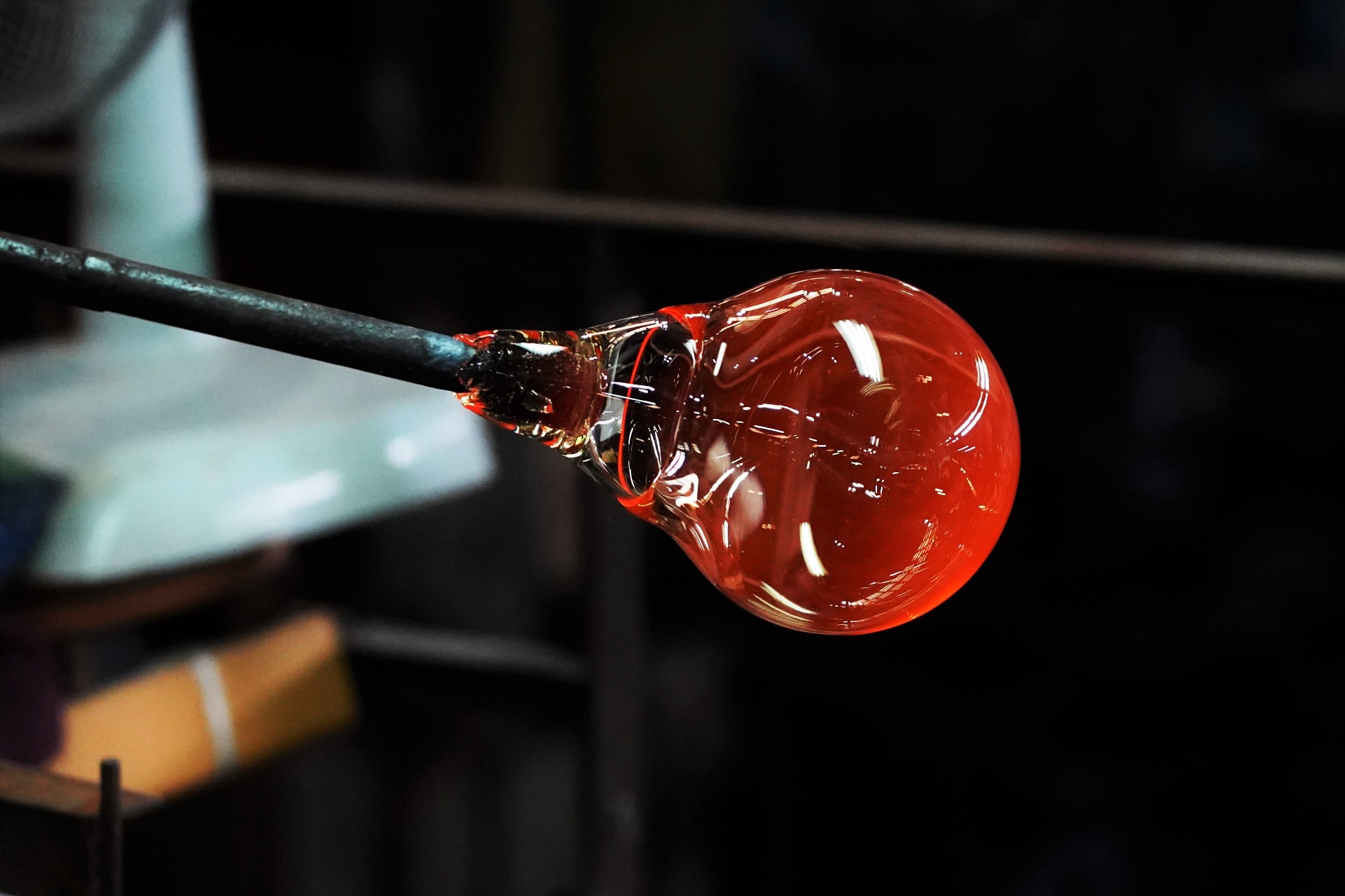 Red molten glass on blowpipe