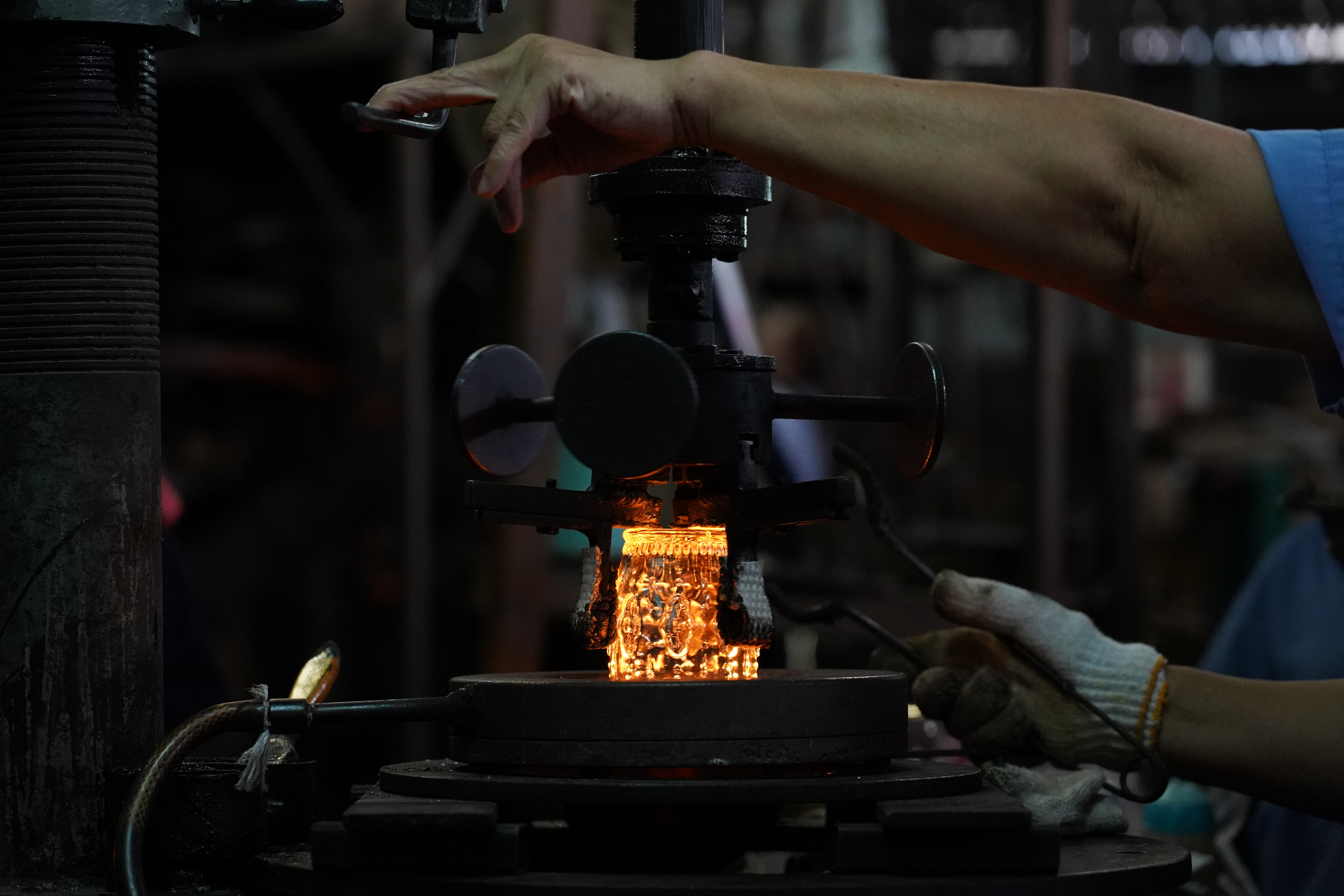 Molten glass glowing in press mold