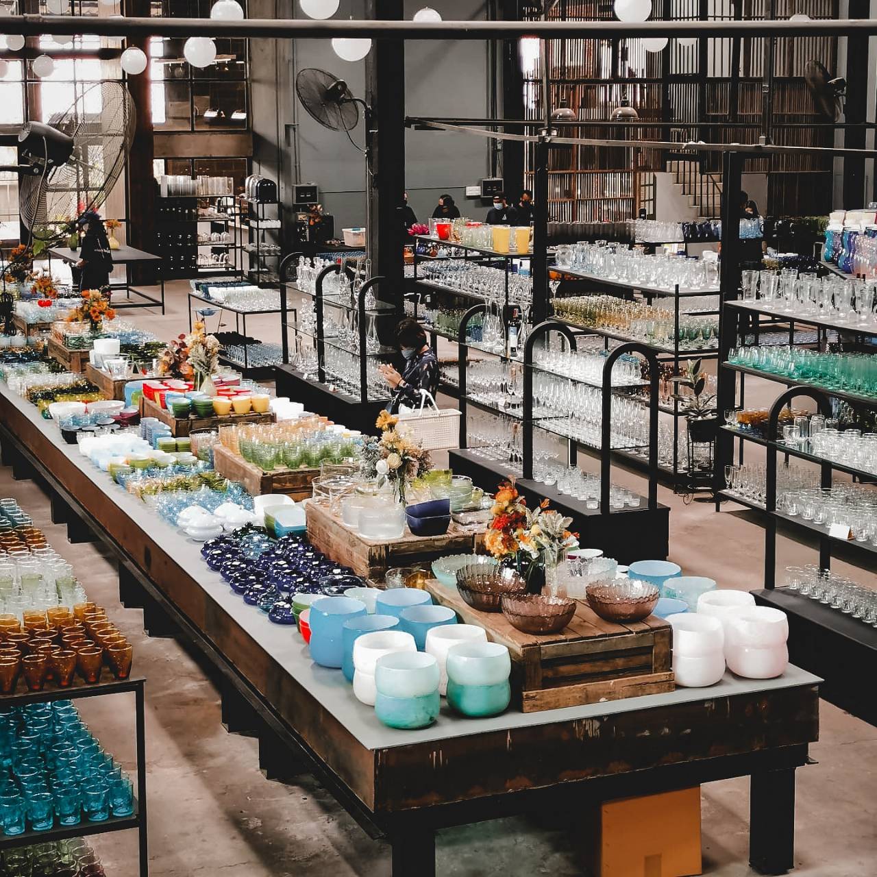 Curated tables of handmade bowls, cups and stemware at Eastern Glass