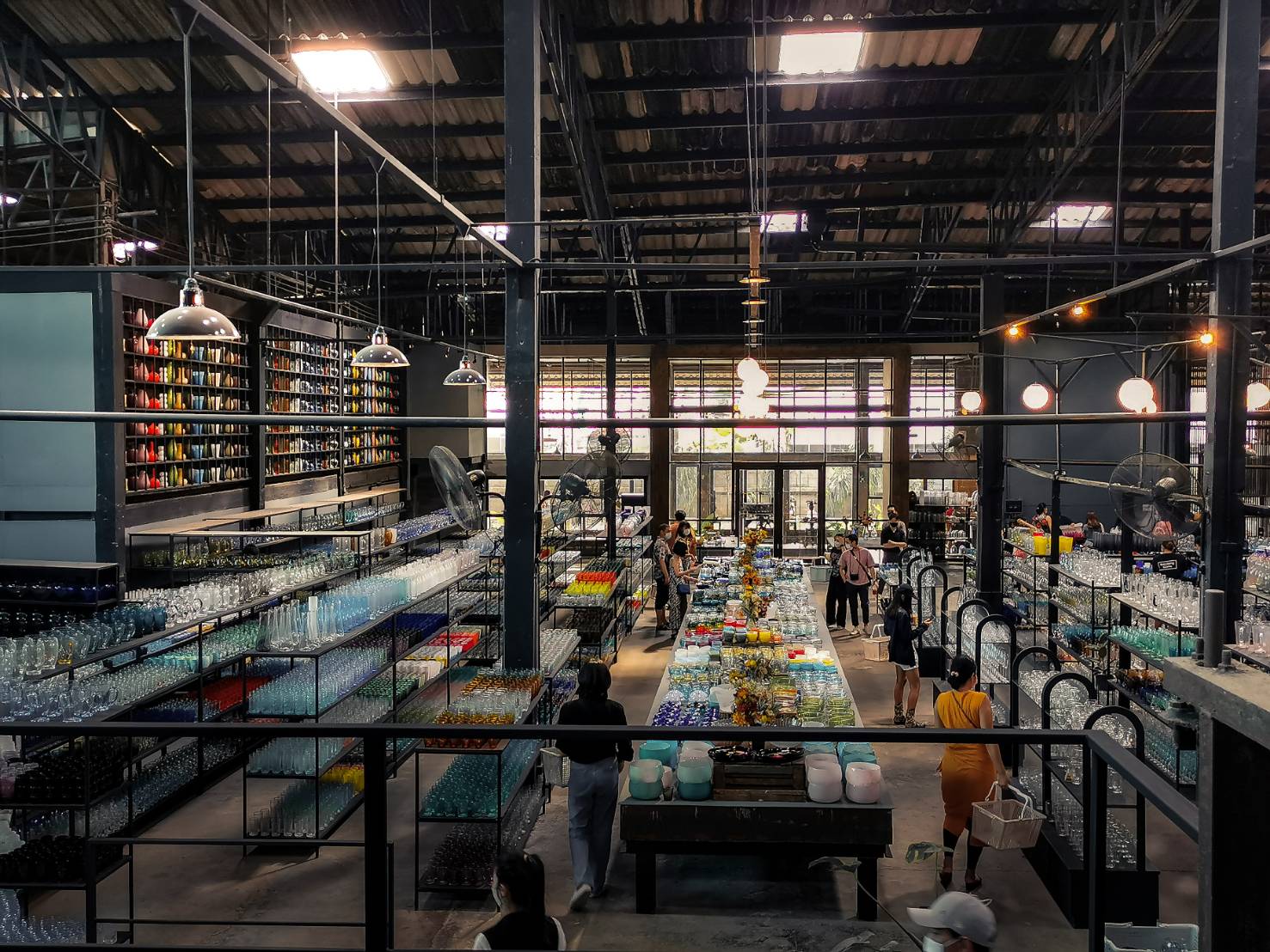 Vast Eastern Glass factory outlet hall with rows of colourful handmade glassware